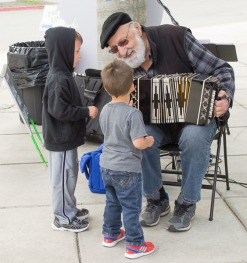 Polka Dan explains the concertina to a pair of young fans.